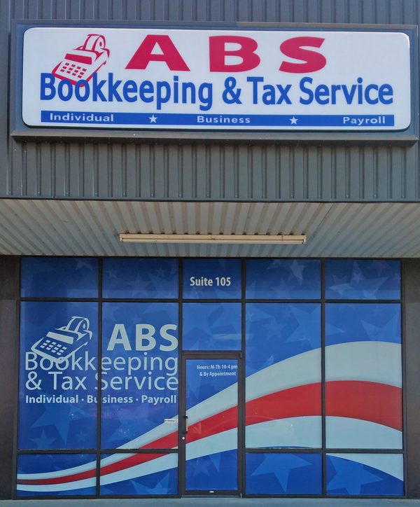The ABS Bookkeeping & Tax Service storefront, Suite 105, with red, white and blue window graphics